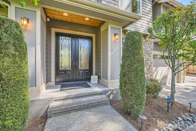 Custom double entry doors with elegant glass panels.