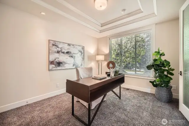 Home office features double glass doors, a large closet, and stunning views of the front yard—often visited by local wildlife for a serene, inspiring workspace.