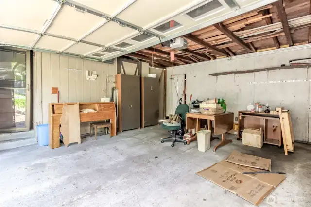 Garage with entry door to small shop