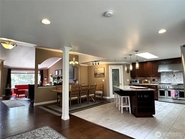 This is such an inviting home and space. The thoughtfully designed 75K remodel added the chef's kitchen with heated floors, tons of counter space and storage, designer lighting, huge island with sink and power, 56" GE Monogram commercial 6 burner stove with built in griddle, double oven & matching exhaust hood. Large pantry, beautiful cabinetry w/ under mount lighting and more.