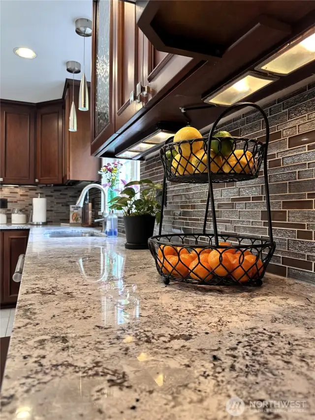 Beautiful high end cabinetry, countertops, backsplash, lighting and fixtures in the chef's kitchen.