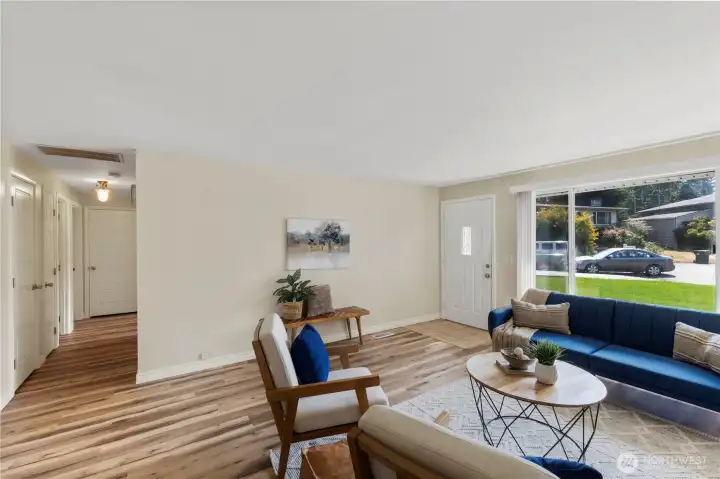 Notice the white millwork previously upgraded in the home, offers a light & bright hallway