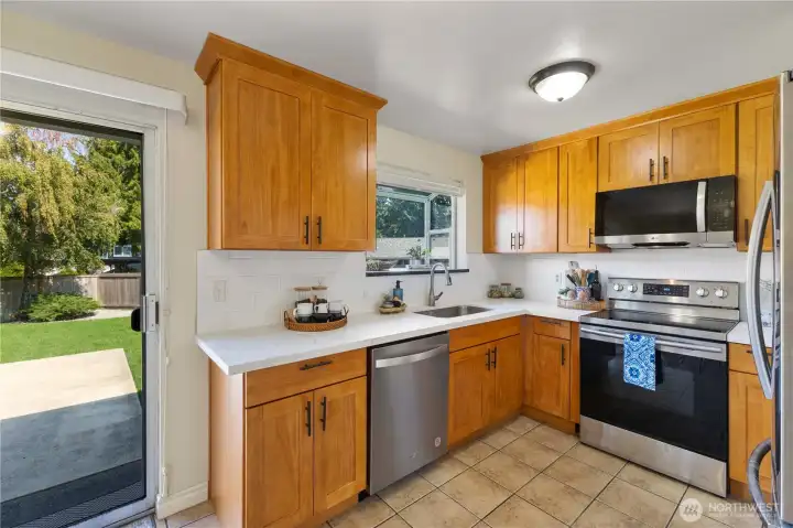 New cabinets, quartz counters,  Microwave, dishwasher, range & backsplash adorn this heart of the home! Grow your favorite herbs in the kitchen Garden window.