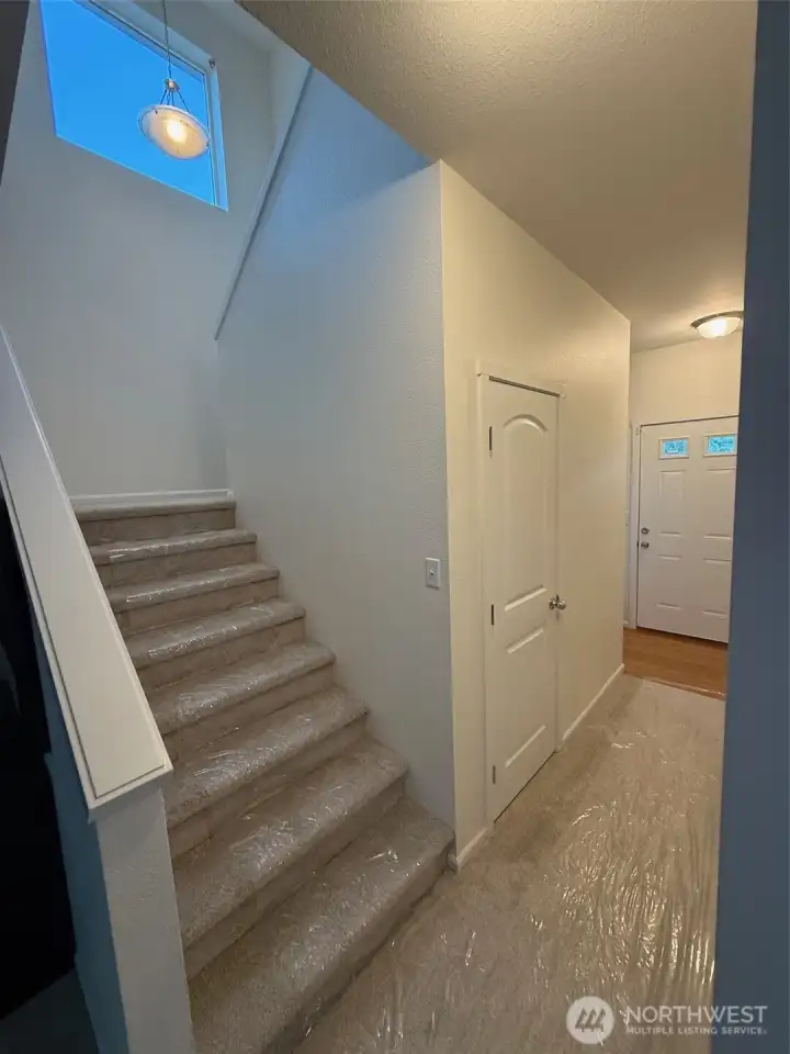 Stairway from entry hall leads to bedrooms, baths and laundry upstairs