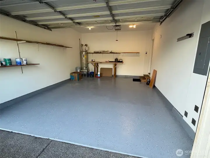 Rustoleum floor coating is attractive and much easier to clean than bare cement!   Workbench and extra shelving