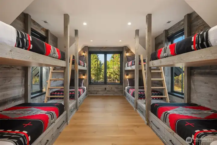 Bunk room is made from Wyoming Snow Fence material, custom cabinetry, custom  steel frames for bunks. Tilting ladders allow access to the upper bunks.