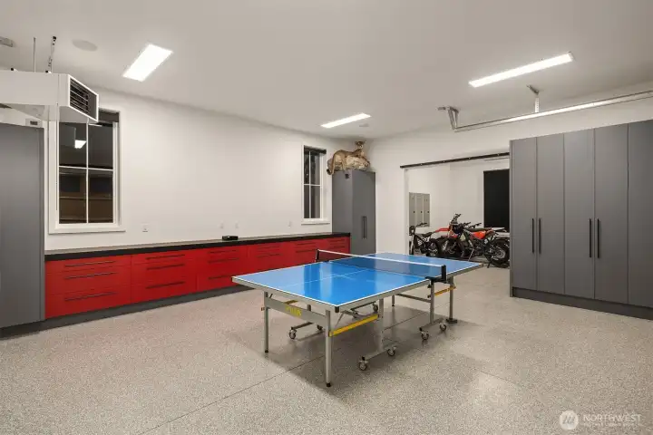 3 car garage with Epoxy floor, Amazing custom cabinets, including 3” thick solid white oak butcherblock counter with black lacquer finish. Reznor heater on independent thermostat to keep garage warm in the winter.  Super bright LED lighting High garage door tracks and wall mount openers to keep the ceiling high and tidy, this  also allows for a car lift which electrical is roughed in for. Electric car charging is ready to go.  All walls, windows, and doors in garage are fully finished and painted.  Garage overhead doors are insulated 3” thick, custom made with insulated glass.