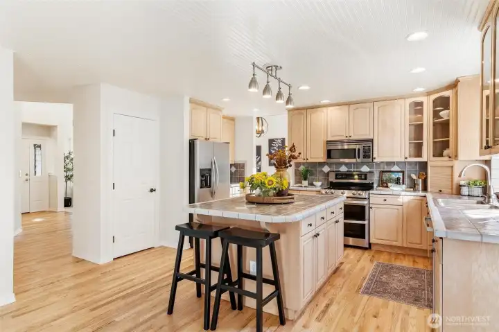 Kitchen with stainless steel appliances, abundant cabinetry, and generous counter space.