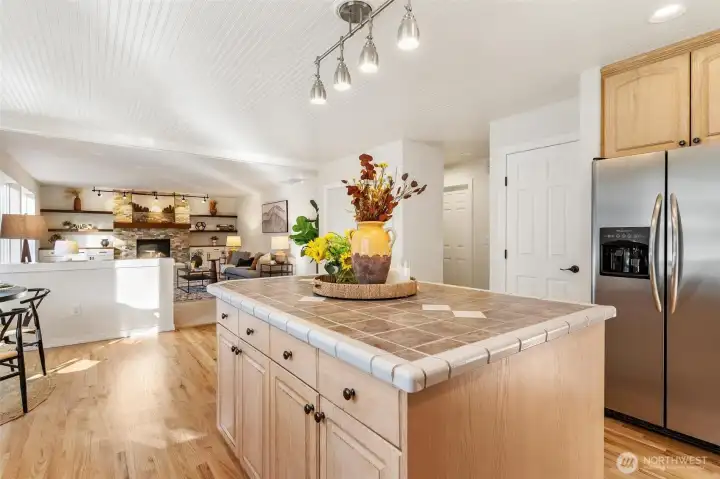 Wide kitchen view highlighting open layout and connection to dining and living areas.