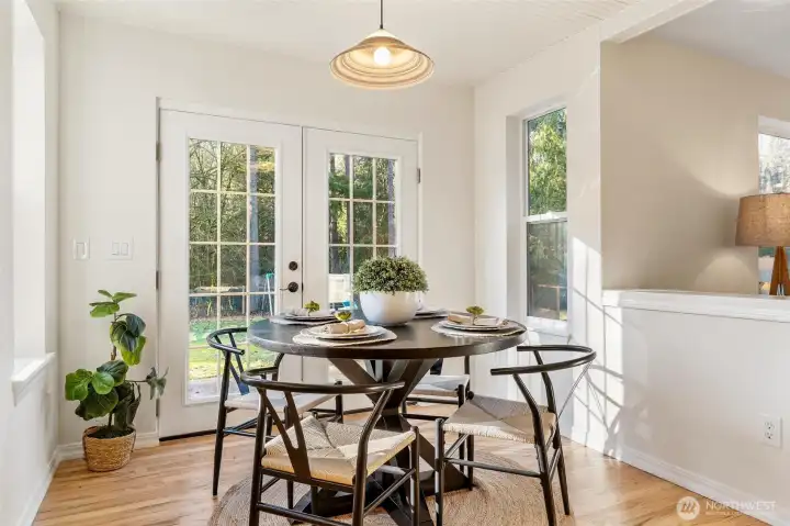 Sun-filled breakfast nook overlooking the backyard, offering a charming space for casual meals.