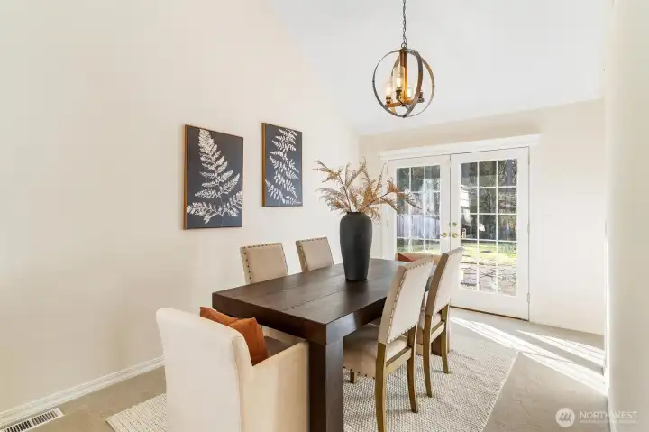 Formal dining room with statement lighting and elegant finishes, perfect for hosting guests.