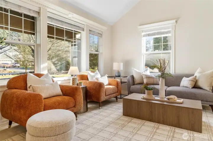 Formal living room featuring large picture windows, abundant natural light, and an open, inviting layout—ideal for entertaining or quiet gatherings in this Maple Valley home for sale.
