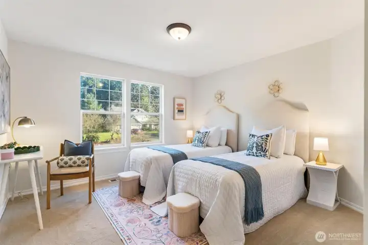 Bright secondary bedroom with neutral palette and flexible layout for guests or family.