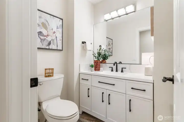 Well-placed lower-level half bath enhances the flexibility of the downstairs area.