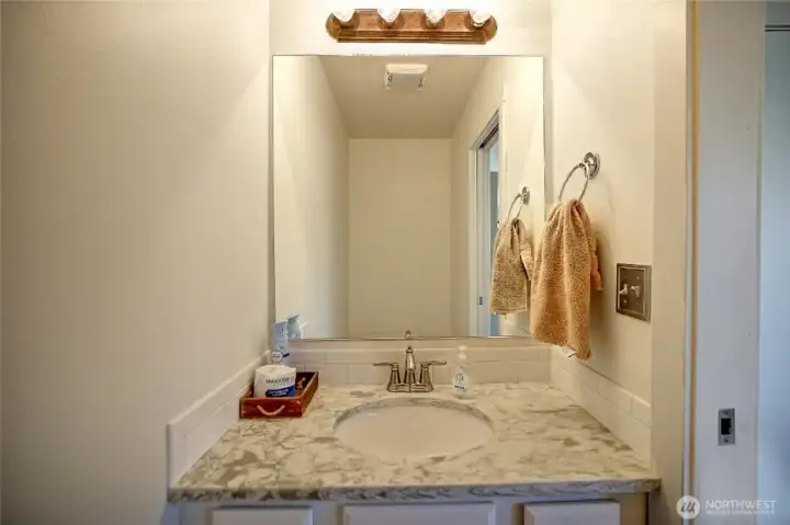 Powder room off of kitchen and dining nook.