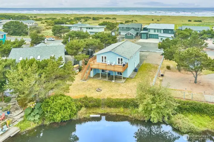 Aerial view of this spacious coastal getaway perfectly located between the canal and the beach.