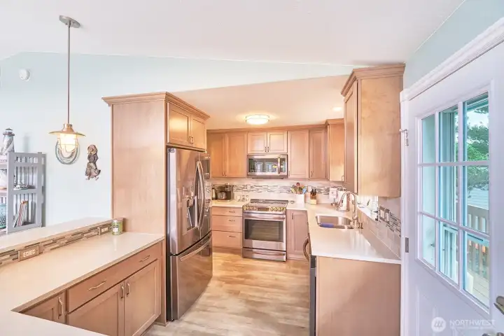 Beautifully updated kitchen with door to south deck for easy BBQ access.