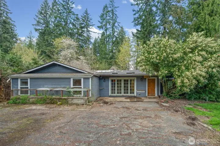 Private, wooded setting with mature trees offers a serene backdrop and endless potential for transformation. Bring your vision to restore or reimagine this home on a spacious lot.