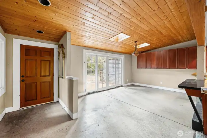Vaulted wood-paneled ceilings and skylights fill the space with natural light and character. Open layout provides a great canvas for modern updates and customization.