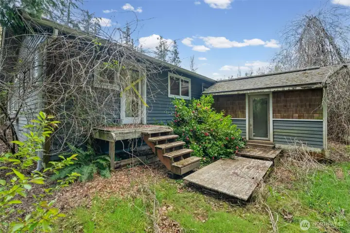 Rear deck and exterior spaces offer a great footprint for outdoor living and entertaining. Ready for repair or rebuild to maximize potential.