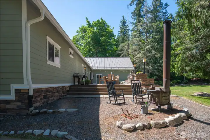 Stunning landscaping sets the stage for entertaining, with a wraparound veranda, back patio, private Bocce Ball court, and a fully equipped outdoor kitchen.