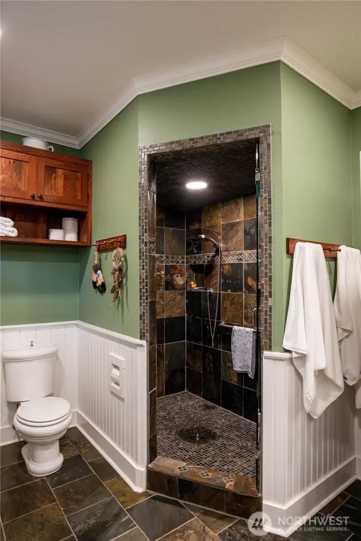 Beautifully tiled walk-in shower in primary bath.