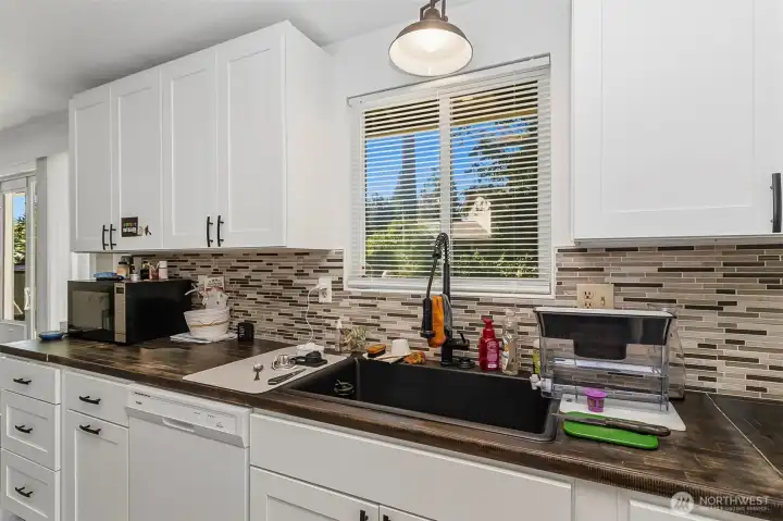 Crisp White Cabinetry~Mosaic Glass Tile Back Splash up to the Cupboards~Gooseneck Faucet~Double Deep Sink~Butcher Block Countertops~