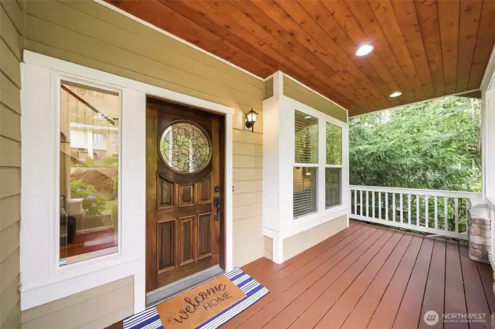 Solid wood craftsman door and covered front porch.