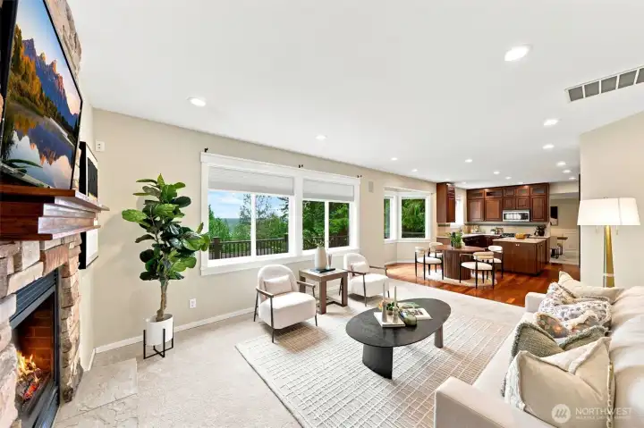 Open concept kitchen, informal dining area and family room with a spacious composite deck out back.
