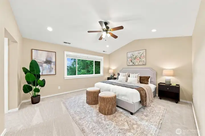 Primary bedroom with vaulted ceilings and peek-a-boo views of Lake Sammamish.