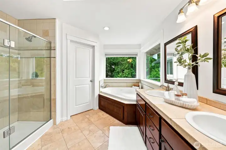 Primary bathroom has a double headed shower, double sinks, private toilet closet and jetted bathtub.