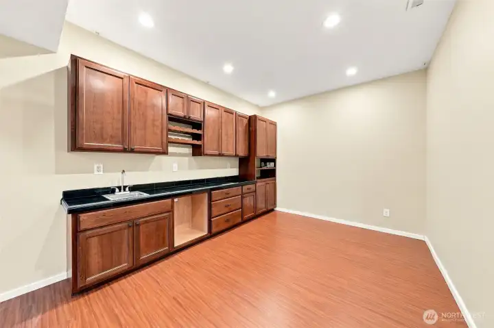Kitchenette in media area. Sink and space for beverage fridge. Wired for 7.1 surround sound.