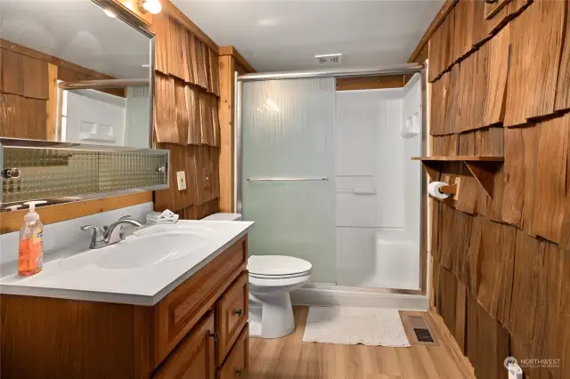The bathroom has stunning cedar accents.