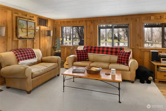 Another view of the living room with a lot of natural light from so many windows.