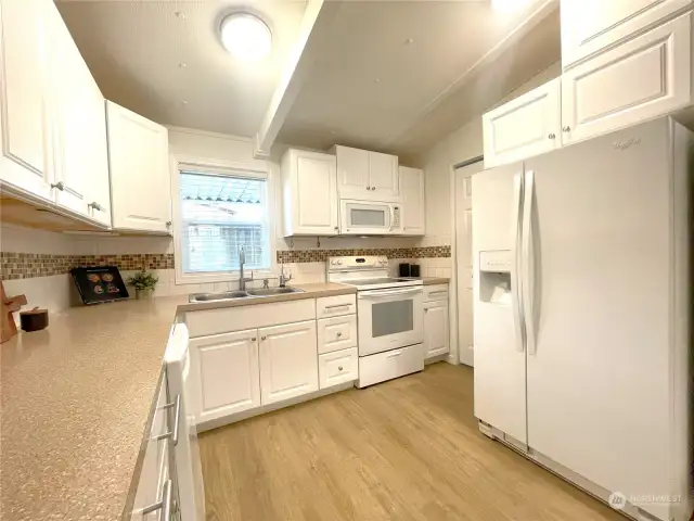 Stylish & Functional – This beautifully updated kitchen boasts modern white cabinetry, offering a clean and timeless look. Expansive countertops provide plenty of room for cooking, while abundant storage ensures a clutter-free space.