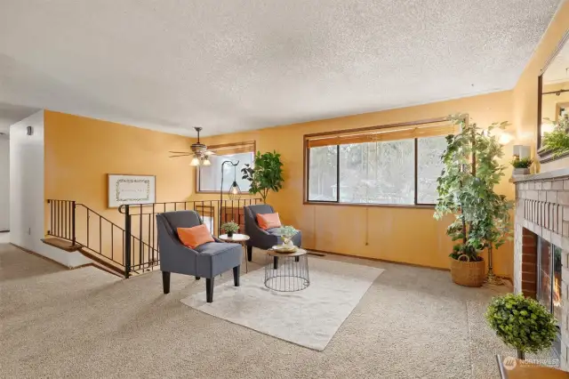 Living Room with natural light, big windows and gas fireplace.