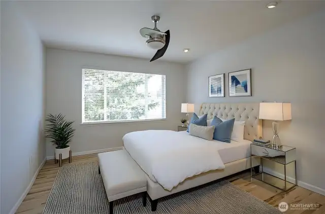 Spacious primary suite featuring radiant hardwood floors that add warmth and elegance - virtually staged for inspiration.
