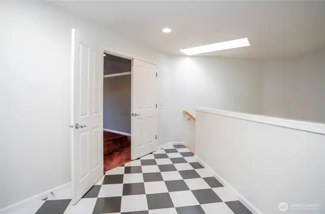 Spacious upper landing with double-door entry leading to the media room, complete with pre-installed theater wiring for an immersive entertainment experience.