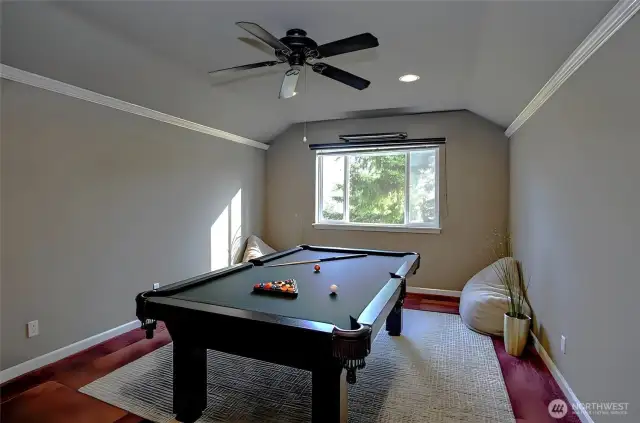 Generous upper-level bonus/media room, pre-wired for a state-of-the-art home theater setup—virtually staged for inspiration.
