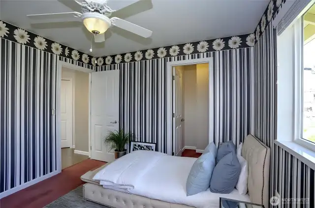 Elegant upper-level guest suite featuring a spacious walk-in closet for added convenience and storage - virtually staged for inspiration.
