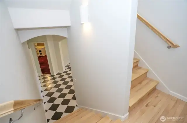 Descending midway down the staircase, you’ll find access to the expansive lower-level living areas.