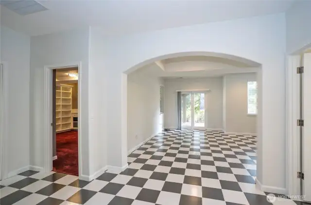 Lower-level landing opens to a spacious family room on the right, while a versatile craft room or office space on the left adapts to suit your needs.