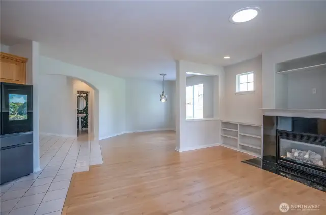 Another stunning view of the spacious, light-filled living and dining areas, where the seamless transition from ceramic tile to hardwood flooring enhances the home's elegant flow.