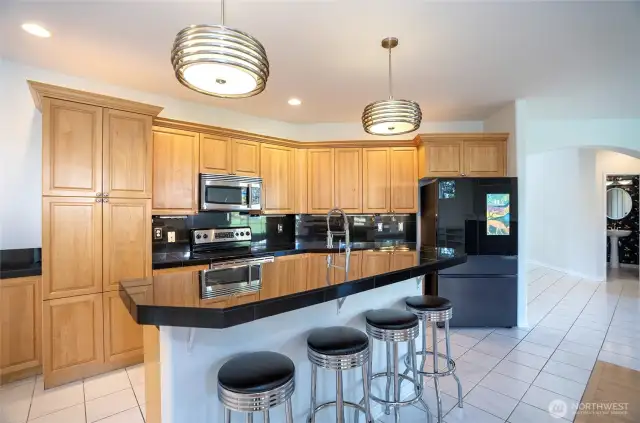 Stunning cabinetry adds elegance to this kitchen, while the spacious eating bar is perfect for casual meals or entertaining guests. The Samsung Family Hub Smart refrigerator connects your family with photos, videos, shopping lists, and more.