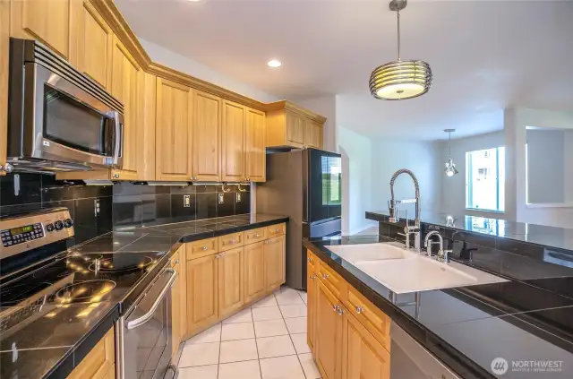 The open-concept kitchen seamlessly connects to the living and dining areas, allowing you to effortlessly entertain and stay engaged with guests.