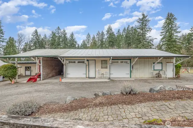 The custom Garage with 0ne 2 car carpeted show space with 1/2 bath. 3-4 car workshop garage, Large truck/boat carport & workspace with high capacity vechicle lift.