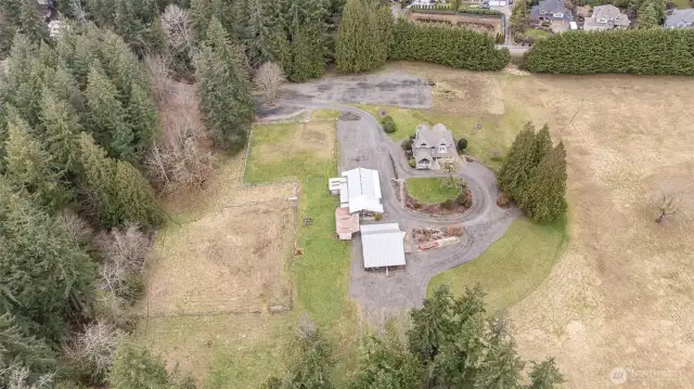 Here you can see from the private dead end gated entry, the residence, the garage shops, stables, barn with loft & more stalls 8-9 stalls in the current configuration. Fenced paddock & open arena area. This equestrian property is ready to make your dreams come true.