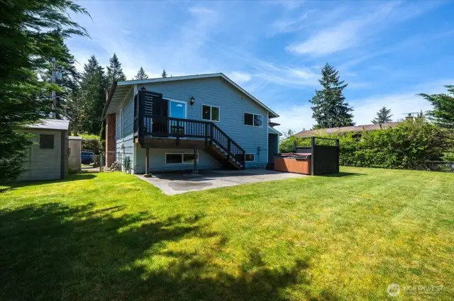 Backyard with two sheds that convey with property.  So much extra storage!