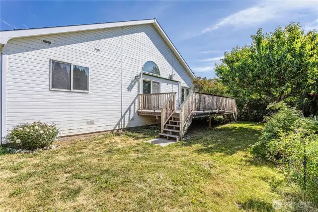 Backyard and deck with mature fruit trees