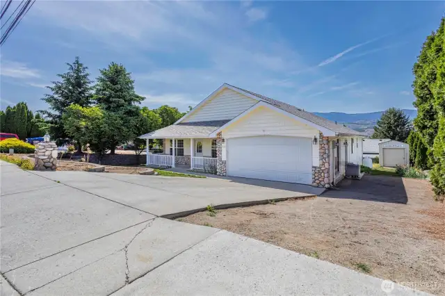 2 car garage with overflow parking option on the side. Shed is not included in the sale.